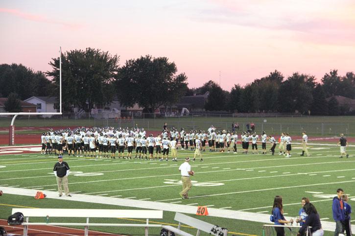 East Varsity prepares to take the field on a Friday night. 